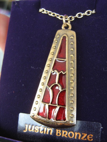 $75 Bronze pendant with cold enamel on gold-plated chain. Design inspired by a gold sword fitting inlaid with garnet found amongst the Staffordshire Hoard